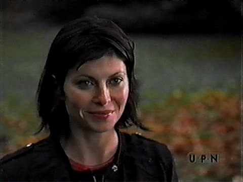 Image of Scarlett Chorvat, as Becca Shaw, standing in a park smiling