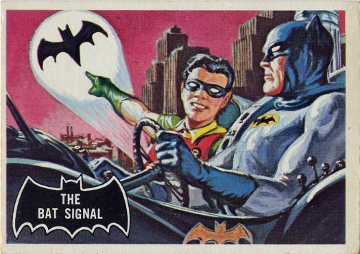 Scan of the front of a Batman trading card depicting Batman and Robin in the Batmobile