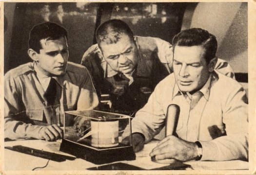 Scan of the front of a Voyage to the Bottom of the Sea trading card depicting crewmembers in the reactor room.