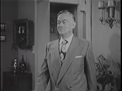 Black and white still from an episode of Meet Corliss Archer showing John Eldredge as Harry Archer.