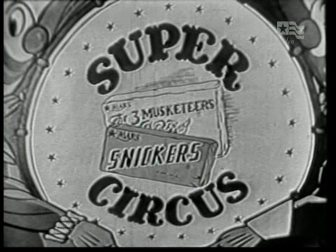 Black and white still from an episode of Super Circus showing the show's title card.