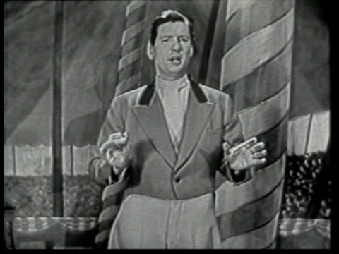 Black and white still from an episode of Super Circus showing ringmaster Claude Kirchner.